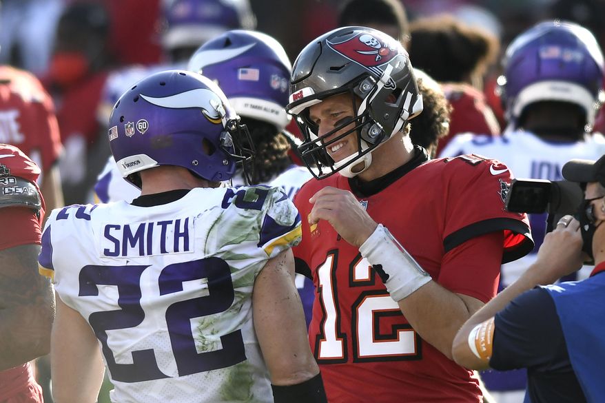 Tampa Bay Buccaneers quarterback Tom Brady (12) talks to Minnesota Vikings strong safety Harrison Smith (22) after an NFL football game Sunday, Dec. 13, 2020, in Tampa, Fla. (AP Photo/Jason Behnken)