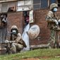 South African National Defense Forces patrol a men&#x27;s hostel in the densely populated Alexandra township east of Johannesburg, Saturday, March 28, 2020, enforcing a strict lockdown in an effort to control the spread of the coronavirus. Responding quickly with one of the world’s harshest lockdowns, South Africa slowed the initial spread of the coronavirus and the country passed its first peak with far less deaths than experts had predicted. (AP Photo/Jerome Delay)