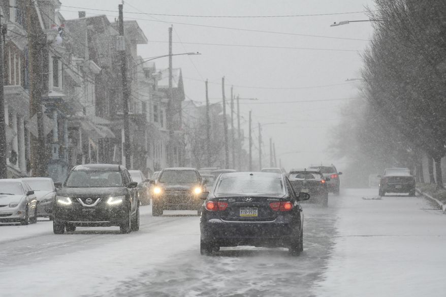 Traffic moves slowly along W. Market Street in Pottsville, Pa., as the snow begins to fall with Winter Storm Gail on Wednesday, Dec. 16, 2020. (Jacqueline Dormer/Republican-Herald via AP)
