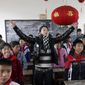 Singer Tan Weiwei, center, gives a singing lesson to students in a rural primary school in Dabo village in Lianyuan city in southern China&#39;s Hunan Province on Dec. 4, 2007. Tan&#39;s latest song &amp;quot;Xiao Juan,&amp;quot; has captivated many on the Chinese internet and has set off a discussion on domestic violence. (Chinatopix via AP)