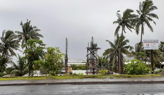 The sky is clouded over in the distance as intermittent rain and wind continue at Suva Harbour in Suva, Fiji,  Friday, Dec. 18, 2020. Dozens of homes have been destroyed by a cyclone Yasa which hit the island nation overnight.(AP Photo/Aileen Torres-Bennett)