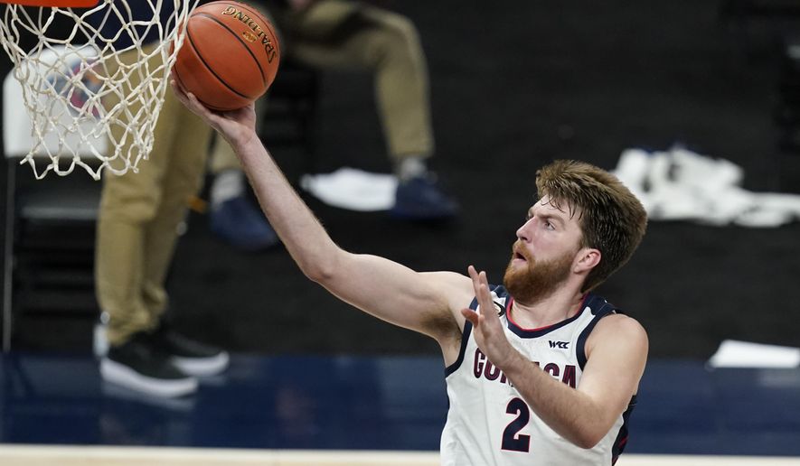 FILE - In this Dec. 2, 2020, file photo, Gonzaga's Drew Timme goes to the basket during the second half of the team's NCAA college basketball game against West Virginia in Indianapolis. Coach Mark Few of top-ranked Gonzaga says the suspension of basketball activities for the past two weeks because of the coronavirus pandemic has ''not helped us in any way, shape or form.″ (AP Photo/Darron Cummings, File)