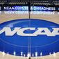 In this March 18, 2015, file photo, the NCAA logo is displayed at center court as work continues at The Consol Energy Center in Pittsburgh, for the NCAA college basketball tournament. (AP Photo/Keith Srakocic, File) **FILE**