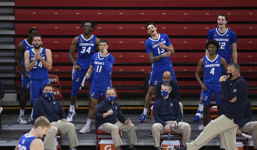 The Creighton bench cheers at the end of second half of an NCAA college basketball game against St. John's, Thursday, Dec. 17, 2020, in New York. (AP Photo/Kevin Hagen)