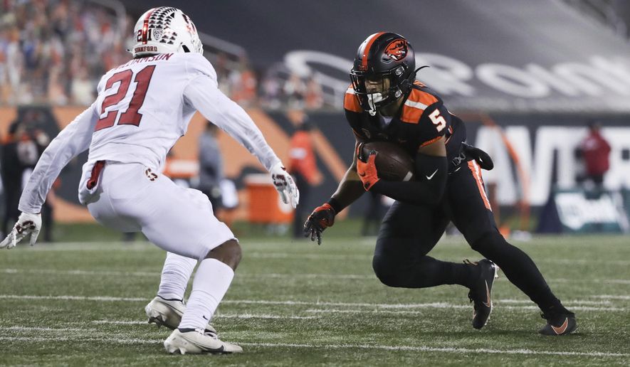 Oregon State wide receiver Kolby Taylor (5) squares off with Stanford strong safety Kendall Williamson (21) during the second half of an NCAA college football game in Corvallis, Ore., Saturday, Dec. 12, 2020. Stanford won 27-24. (AP Photo/Amanda Loman)