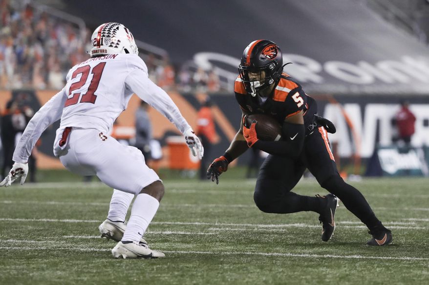 Oregon State wide receiver Kolby Taylor (5) squares off with Stanford strong safety Kendall Williamson (21) during the second half of an NCAA college football game in Corvallis, Ore., Saturday, Dec. 12, 2020. Stanford won 27-24. (AP Photo/Amanda Loman)