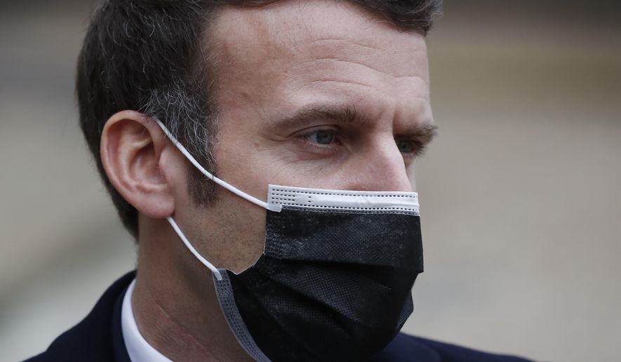 French President Emmanuel Macron reacts as he meets Portuguese Prime Minister Antonio Costa, Wednesday, Dec. 16, 2020 in Paris. French President Emmanuel Macron has tested positive for COVID-19, the presidential Elysee Palace announced on Thursday. (AP Photo/Francois Mori)