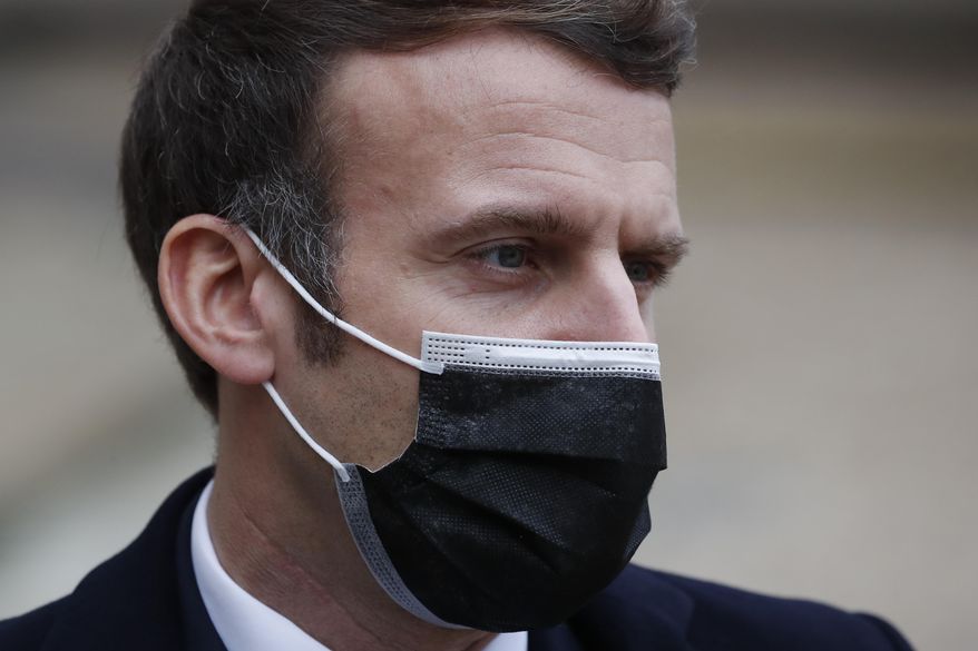 French President Emmanuel Macron reacts as he meets Portuguese Prime Minister Antonio Costa, Wednesday, Dec. 16, 2020 in Paris. French President Emmanuel Macron has tested positive for COVID-19, the presidential Elysee Palace announced on Thursday. (AP Photo/Francois Mori)