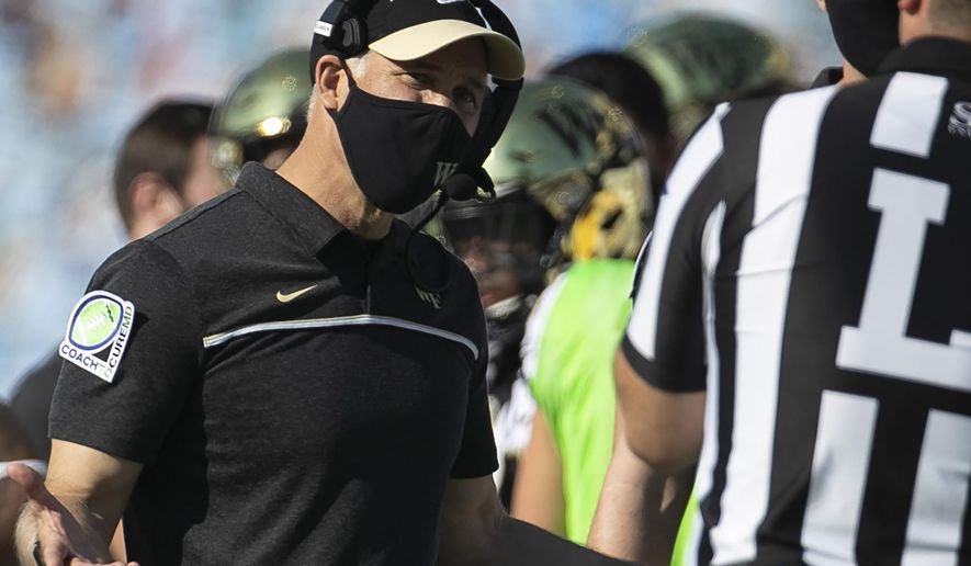 FILE - Wake Forest head coach Dave Clawson argues with an official during the first half of an NCAA college football game against North Carolina in Chapel Hill, N.C., in this Saturday, Nov. 14, 2020, file photo. Clawson's Demon Deacons play their first game since Nov. 14 when they visit Louisville on Saturday, Dec. 12. (Robert Willett/The News & Observer via AP, File)