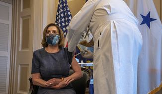 Speaker of the House Nancy Pelosi, D-Calif., receives a Pfizer-BioNTech COVID-19 vaccine shot by Dr. Brian Monahan, attending physician Congress of the United States in Washington, Friday, Dec. 18, 2020. (Ken Cedeno/Pool via AP)