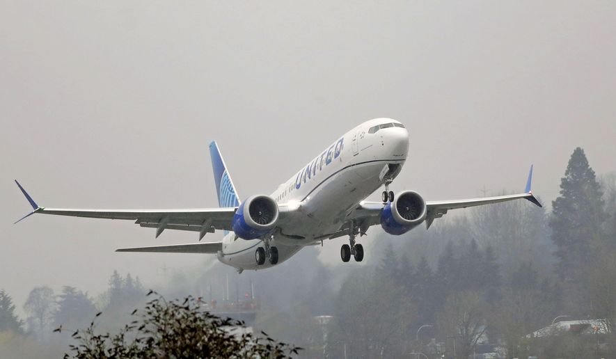 FILE - In this Wednesday, Dec. 11, 2019 file photo, a United Airlines Boeing 737 Max airplane takes off in the rain at Renton Municipal Airport in Renton, Wash. Boeing improperly influenced a test designed to see how quickly pilots could respond to malfunctions on the Boeing 737 Max, and Federal Aviation Administration officials may have obstructed a review of two deadly crashes involving the plane, Senate investigators say. In a report released Friday, Dec. 18, 2020 the Senate Commerce Committee also said the FAA continues to retaliate against whistleblowers.(AP Photo/Ted S. Warren, File)