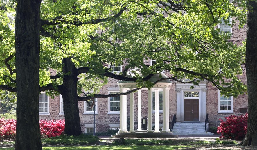 FILE - In this April 20, 2015, file photo, the Old Well is seen near the South Building on campus at The University of North Carolina in Chapel Hill, N.C. Fraternity members at North Carolina's flagship school were part of a drug trafficking ring that for years funneled huge quantities of drugs into three college campuses, federal prosecutors said Thursday, Dec. 17, 2020. (AP Photo/Gerry Broome, File)