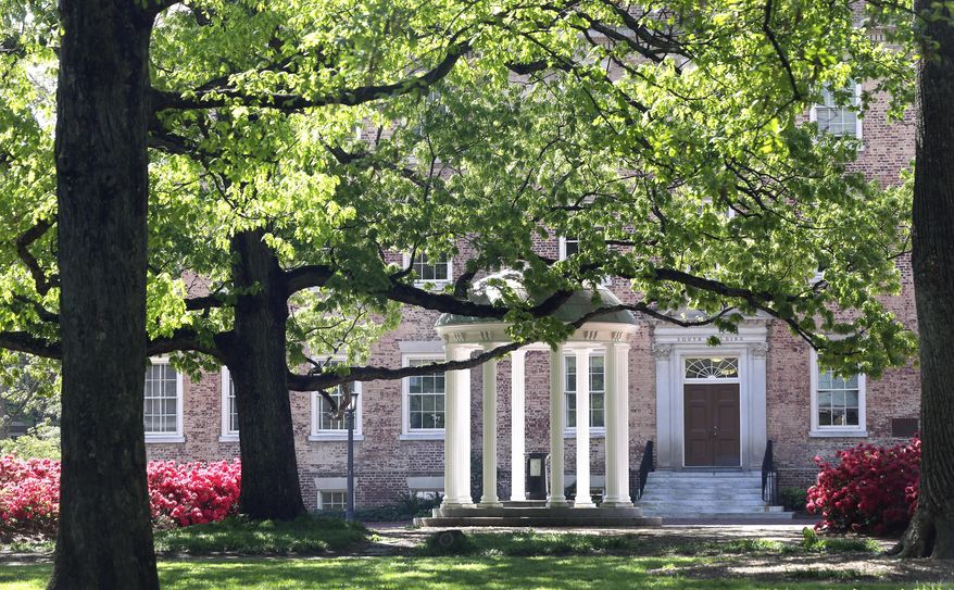 FILE - In this April 20, 2015, file photo, the Old Well is seen near the South Building on campus at The University of North Carolina in Chapel Hill, N.C. Fraternity members at North Carolina's flagship school were part of a drug trafficking ring that for years funneled huge quantities of drugs into three college campuses, federal prosecutors said Thursday, Dec. 17, 2020. (AP Photo/Gerry Broome, File)