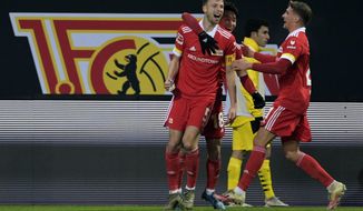 Union&#39;s Marvin Friedrich, left, celebrates after scoring his side&#39;s second goal of the game during the German Bundesliga soccer match between 1. FC Union Berlin and Borussia Dortmund at the Stadion Alte Forsterei in Berlin, Friday, Dec. 18, 2020. (Soeren Stache/Pool Photo via AP)