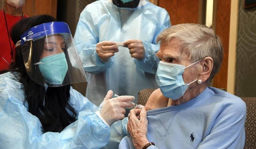 Mary Lou Galushko gives Jeanne Peters, 95, a rehab patient at The Reservoir, a nursing facility, the first COVID-19 vaccination at the nursing home Friday, Dec. 18, 2020, in West Hartford, Conn. (AP Photo/Stephen Dunn, Pool)