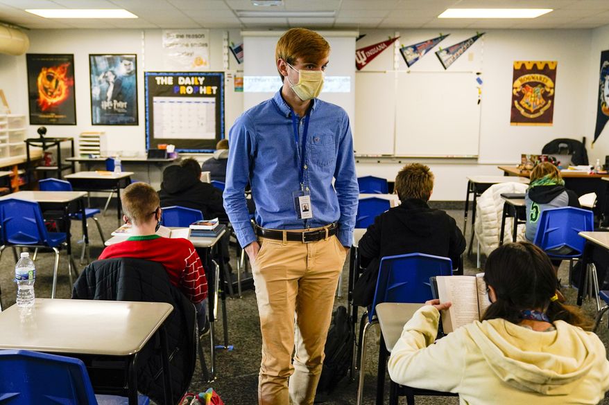 Cooper Hanson, a substitute teacher at the Greenfield Intermediate School in Greenfield, Ind., is photographed Thursday, Dec. 10, 2020. Hanson, a student at Hanover College, is one of several college students being recruited to work as substitute teachers in schools during the pandemic. (AP Photo/Michael Conroy)