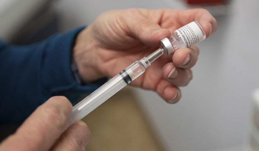 Director of Nursing Kathleen Napier prepares a dose of the COVID-19 vaccine on Wednesday, Dec. 16, 2020, at the Cabell-Huntington Health Department in Huntington, W.Va. (Sholten Singer/The Herald-Dispatch via AP)