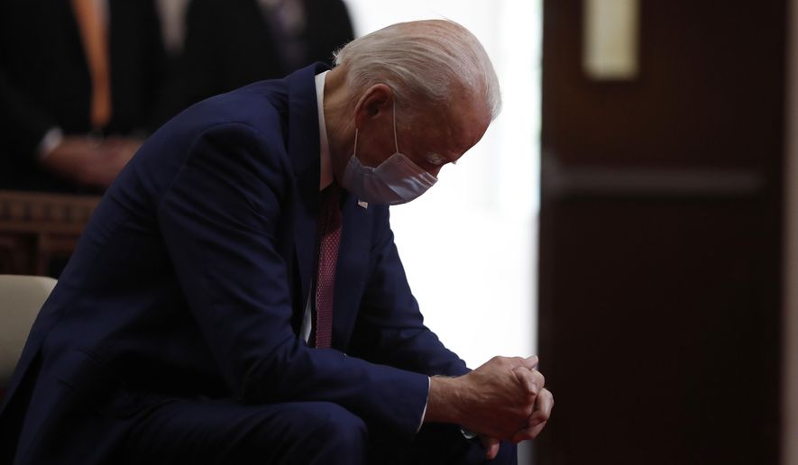 In this Monday, June 1, 2020, photo, Democratic presidential candidate and former Vice President Joe Biden bows his head in prayer as he visits Bethel AME Church in Wilmington, Del. Biden will be just the second Roman Catholic president in U.S. history, after John F. Kennedy. (AP Photo/Andrew Harnik) ** FILE **