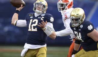 Notre Dame quarterback Ian Book throws a pass against Clemson during the Atlantic Coast Conference championship NCAA college football game, Saturday, Dec. 19, 2020, in Charlotte, N.C. (Jeff Siner/The News &amp;amp; Observer via AP)