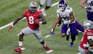 Ohio State running back Trey Sermon (8) runs for the end zone to score past Northwestern defensive back Cameron Mitchell (21) during the second half of the Big Ten championship NCAA college football game, Saturday, Dec. 19, 2020, in Indianapolis. (AP Photo/Darron Cummings)