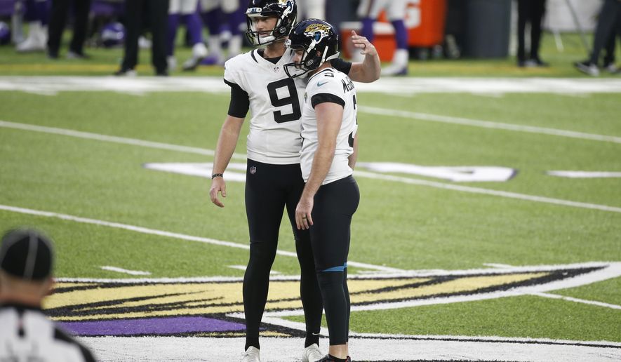 Jacksonville Jaguars place kicker Chase McLaughlin, right, reacts with teammate Logan Cooke (9) after missing a field goal in the second half of an NFL football game against the Minnesota Vikings, Sunday, Dec. 6, 2020, in Minneapolis. The Vikings won 27-24 in overtime. (AP Photo/Bruce Kluckhohn)