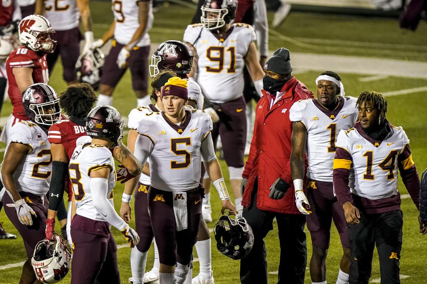 Minnesota quarterback Zack Annexstad (5) walks off the field with teammates after Wisconsindefeated them in overtime of an NCAA college football game Saturday, Dec. 19, 2020, in Madison, Wis. (AP Photo/Andy Manis)