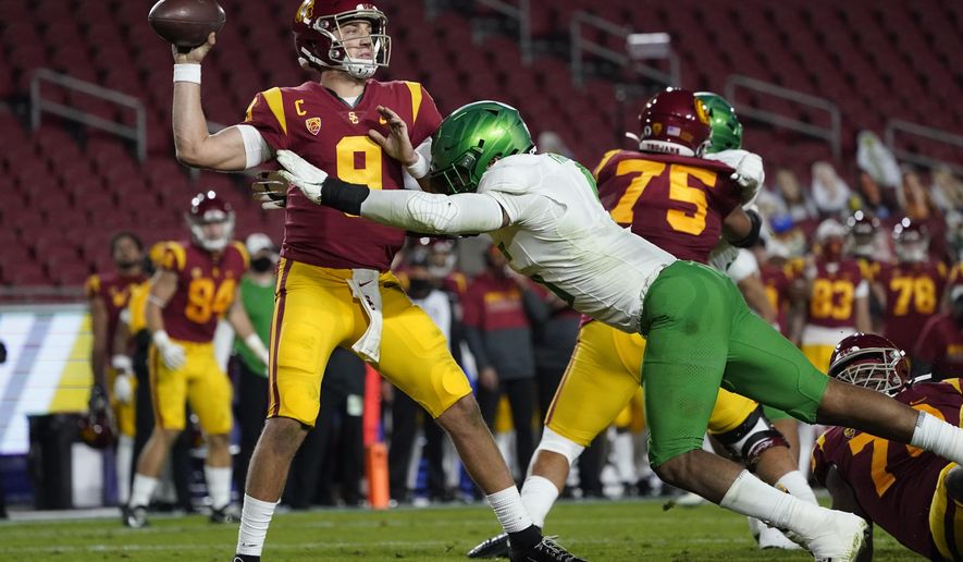 Southern California quarterback Kedon Slovis (9) is tackled by Oregon defensive end Kayvon Thibodeaux (5) during the second quarter of an NCAA college football game for the Pac-12 Conference championship Friday, Dec 18, 2020, in Los Angeles. (AP Photo/Ashley Landis)