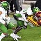 USC Running back Stephen Carr, right, runs for a first down and is tackled by Oregon safety Jamal Hill first half of an NCAA college football game at the Los Angeles Memorial Coliseum in Los Angeles on Friday, Dec. 18, 2020. (Keith Birmingham/The Orange County Register via AP)