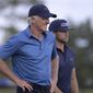Greg Norman, left, of Australia, walks with his son Greg Norman Jr. on the 18th fairway after hitting their tee shots during the first round of the PNC Championship golf tournament, Saturday, Dec. 19, 2020, in Orlando, Fla. (AP Photo/Phelan M. Ebenhack)