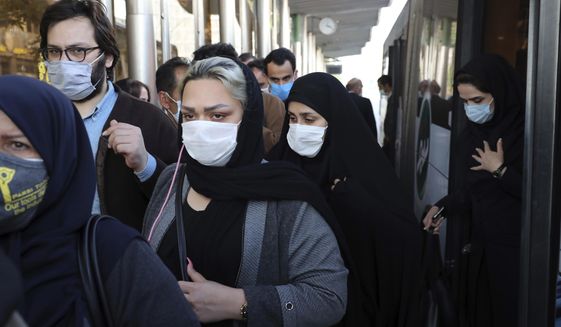 FILE - In this Oct. 11, 2020, file photo, people wear protective face masks to help prevent the spread of the coronavirus in downtown Tehran, Iran. Though Iran faces crushing U.S. sanctions, there still remain ways for Tehran to obtain coronavirus vaccines as it suffers the Mideast&#39;s worst outbreak of the pandemic. (AP Photo/Ebrahim Noroozi, File)