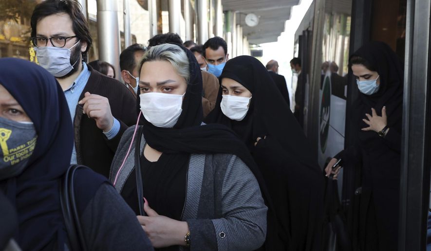 FILE - In this Oct. 11, 2020, file photo, people wear protective face masks to help prevent the spread of the coronavirus in downtown Tehran, Iran. Though Iran faces crushing U.S. sanctions, there still remain ways for Tehran to obtain coronavirus vaccines as it suffers the Mideast&#39;s worst outbreak of the pandemic. (AP Photo/Ebrahim Noroozi, File)