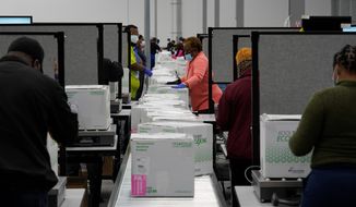 Boxes containing the Moderna COVID-19 vaccine are prepared in Olive Branch, Mississippi, on Sunday. The first boxes are set to arrive Monday. (Associated Press)