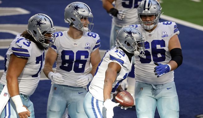 Dallas Cowboys&#x27; Joe Looney (73), Dalton Schultz (86), and Connor McGovern (66) celebrate with Michael Gallup (13) after his touchdown catch in the first half of an NFL football game against the San Francisco 49ers in Arlington, Texas, Sunday, Dec. 20, 2020. (AP Photo/Ron Jenkins)