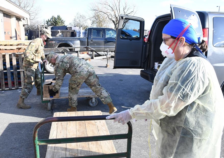 Soldiers from the 10th Mountain Division (LI) chapter of the Sgt. Audie Murphy Club unload a van full of food for the staff at United Helpers in Ogdensburg on Dec. 15, in a show of support and community spirit for those on the front line in the fight against COVID-19. (Photo by Mike Strasser, Fort Drum Garrison Public Affairs)