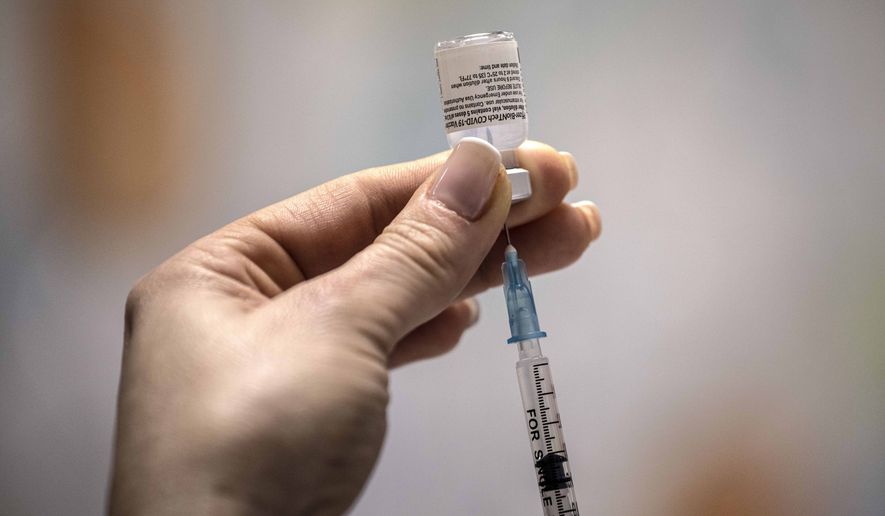 An Israeli nurse prepares a COVID-19 vaccine at the Barzilai Medical Center in the southern Israeli city of Ashkelon, Sunday, Dec. 20, 2020. (AP Photo/Tsafrir Abayov)