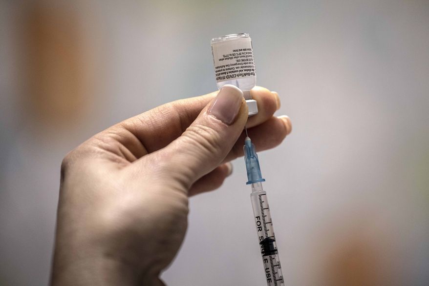 An Israeli nurse prepares a COVID-19 vaccine at the Barzilai Medical Center in the southern Israeli city of Ashkelon, Sunday, Dec. 20, 2020. (AP Photo/Tsafrir Abayov)