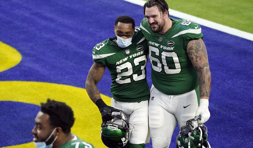 New York Jets cornerback Arthur Maulet (23) hugs center Connor McGovern (60) after a win over the Los Angeles Rams during an NFL football game Sunday, Dec. 20, 2020, in Inglewood, Calif. (AP Photo/Ashley Landis)