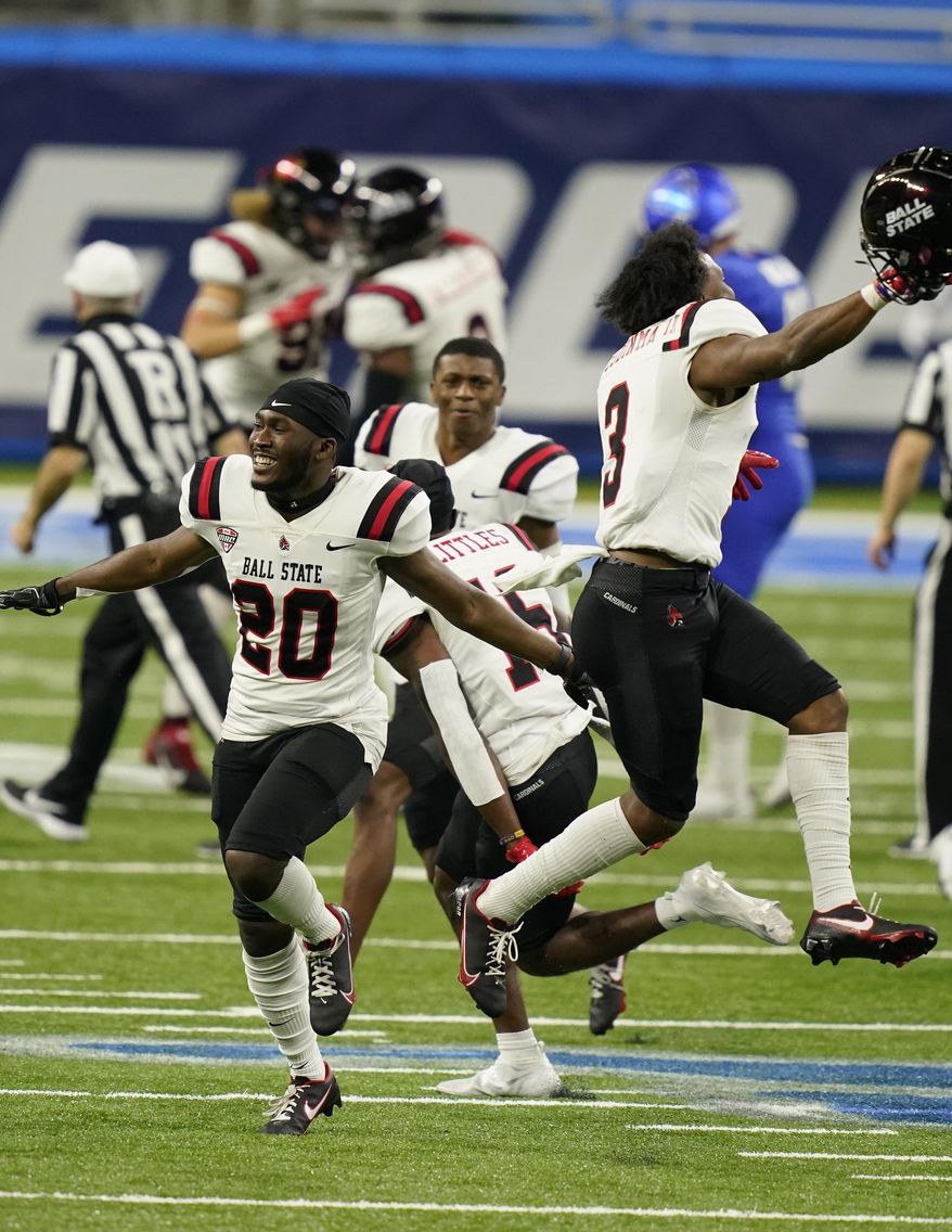 Ball State players run onto the field after the team defeated Buffalo during the Mid-American Conference championship NCAA college football game, Friday, Dec. 18, 2020 in Detroit. (AP Photo/Carlos Osorio)