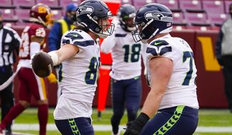 Seattle Seahawks tight end Jacob Hollister (86) celebrating his touchdown with teammate Seattle Seahawks center Ethan Pocic (77) during the first half of an NFL football game against the Washington Football Team, Sunday, Dec. 20, 2020, in Landover, Md. (AP Photo/Andrew Harnik)