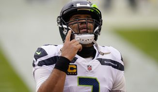 Seattle Seahawks quarterback Russell Wilson (3) points upwards before the start of the first half of an NFL football game against the Washington Football Team, Sunday, Dec. 20, 2020, in Landover, Md. (AP Photo/Andrew Harnik)