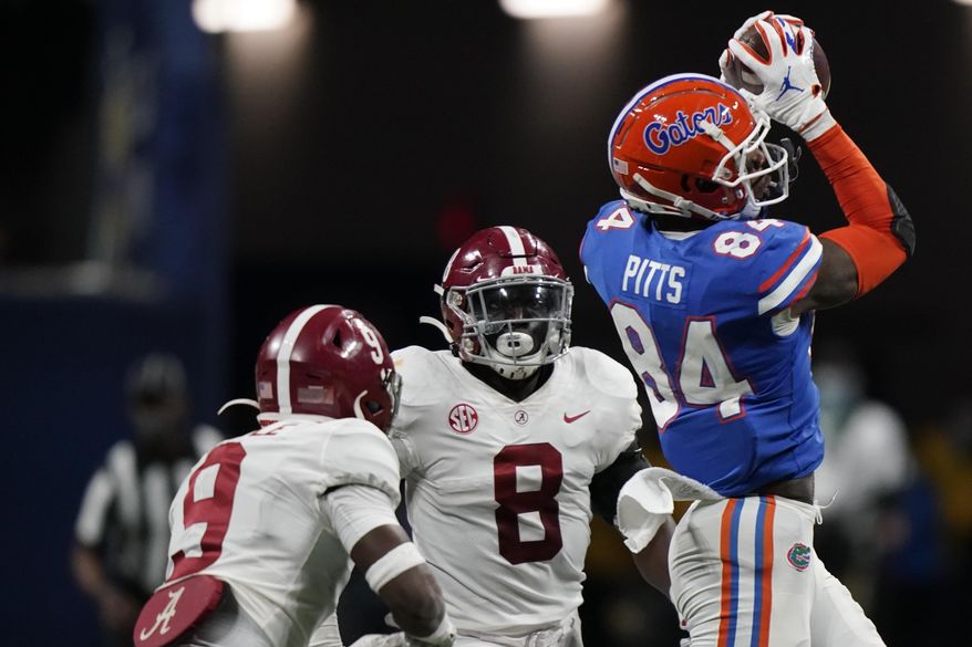 Florida tight end Kyle Pitts (84) makes the catch ahead of Alabama linebacker Christian Harris (8) during the second half of the Southeastern Conference championship NCAA college football game, Saturday, Dec. 19, 2020, in Atlanta. (AP Photo/Brynn Anderson)