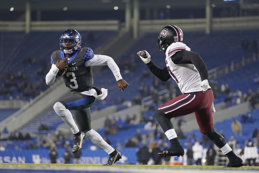 Kentucky quarterback Terry Wilson (3) scrambles during the second half of the team's NCAA college football game against South Carolina, Saturday, Dec. 5, 2020, in Lexington, Ky. (AP Photo/Bryan Woolston)