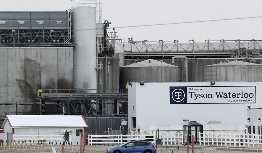 In this Friday, May 1, 2020, photo, a worker leaves the Tyson Foods plant in Waterloo, Iowa. The coronavirus devastated the nation&#x27;s meatpacking communities in Iowa, Nebraska, and Minnesota earlier in the year.  (AP Photo/Charlie Neibergall, File)  **FILE**