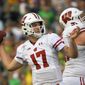 FILE - In this Jan. 1, 2020, file photo, Wisconsin quarterback Jack Coan passes against Oregon during first half of the Rose Bowl NCAA college football game in Pasadena, Calif. Coan has entered the transfer portal after an injury-riddled season in which he did not play. (AP Photo/Mark J. Terrill, File)