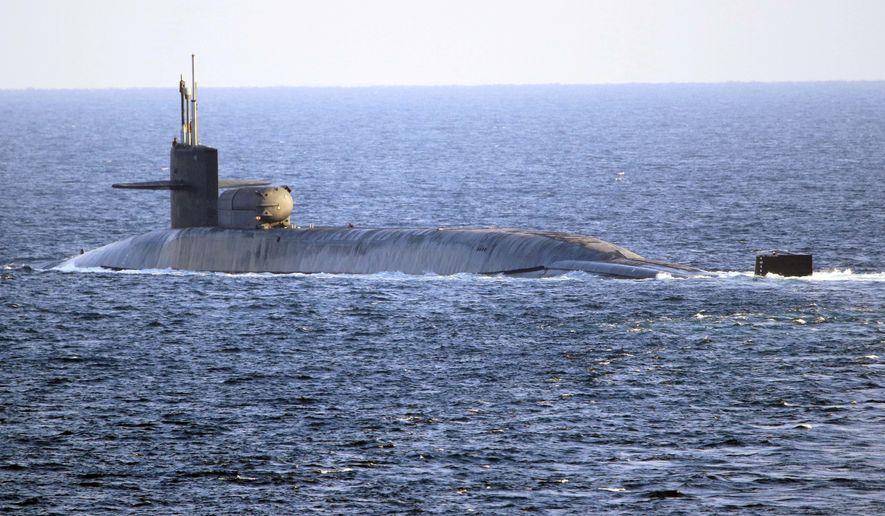 In this photo made available by the U.S. Navy, the guided-missile submarine USS Georgia transits the Strait of Hormuz in Persian Gulf, Monday, Dec. 21, 2020. The USS Georgia traversed the strategically vital waterway between Iran and the Arabian Peninsula on Monday, the U.S. Navy said, a rare announcement that comes amid rising tensions with Iran. (Mass Communication Specialist 2nd Class Indra Beaufort/U.S. Navy via AP)