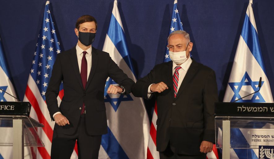 White House senior adviser Jared Kushner, left, elbow bumps Israeli Prime Minister Benjamin Netanyahu during a news conference in Jerusalem, Monday, Dec. 21, 2020. (Ronen Zvulun/Pool Photo via AP)