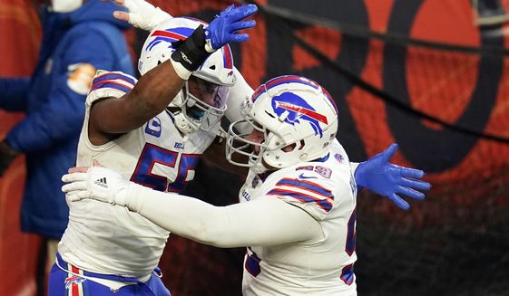 Buffalo Bills defensive end Jerry Hughes, left, celebrates with teammate defensive tackle Harrison Phillips after scoring a touchdown off a fumble recovery during the second half of an NFL football game against the Denver Broncos, Saturday, Dec. 19, 2020, in Denver. (AP Photo/Jack Dempsey)