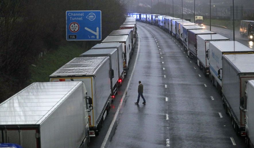 Lorries are parked on the M20 near Folkestone, Kent, England as part of Operation Stack after the Port of Dover was closed and access to the Eurotunnel terminal suspended following the French government&#39;s announcement, Monday, Dec. 21, 2020.  France banned all travel from the UK for 48 hours from midnight Sunday, including trucks carrying freight through the tunnel under the English Channel or from the port of Dover on England&#39;s south coast. (Steve Parsons/PA via AP)