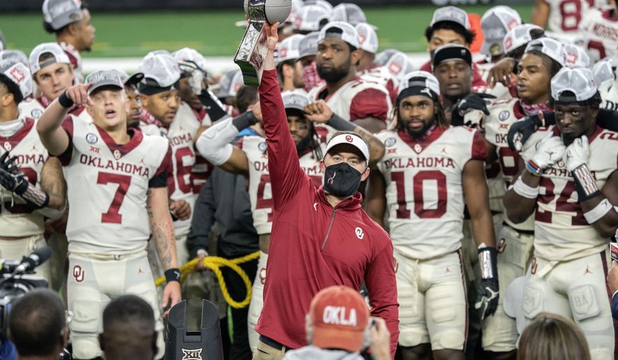 Oklahoma head coach Lincoln Riley hosts the Big 12 Conference championship trophy after defeating Iowa State 27-21 in an NCAA college football game, Saturday, Dec. 19, 2020, in Arlington, Texas. (AP Photo/Jeffrey McWhorter)