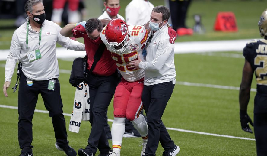 Kansas City Chiefs running back Clyde Edwards-Helaire (25) is helped off the field after being injured in the second half of an NFL football game against the New Orleans Saints in New Orleans, Sunday, Dec. 20, 2020. (AP Photo/Brett Duke)